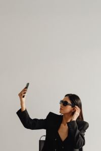Kaboompics - Woman in a Black Suit Taking a Smartphone Selfie