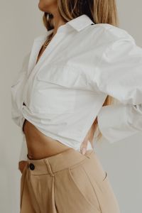 Kaboompics - Minimal Fashion Side View of Woman in White Shirt and Beige Trousers