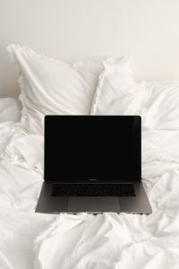 Kaboompics - Work From Bed Lifestyle with Laptop on White Bedding