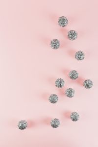 Silver Christmas Baubles on Soft Pink Background with Copy Space