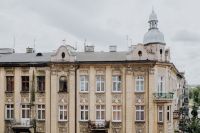 Kaboompics - Ornate Krakow Apartment Facade and Tree-Lined Street