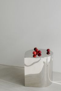 Kaboompics - Close-Up Red Plums on Reflective Chrome Table