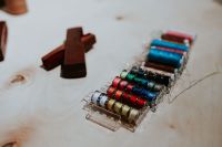 Kaboompics - Multicolored Thread Spools in a Clear Sewing Organizer