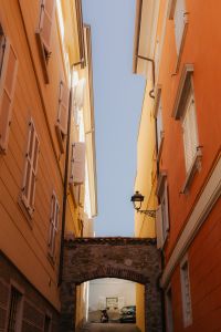Kaboompics - Parked Cars Beside a Green Garden Wall on Cobblestones