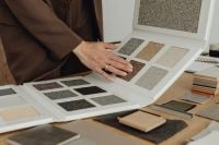 Kaboompics - Hands Comparing Exterior Plaster Colors for Facade Design