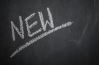 Kaboompics - NEW Word Underlined in White Chalk on a Dark Blackboard, Product Launch Announcement
