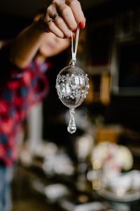 Kaboompics - Hand Holding a Silver Wire Easter Egg Ornament by a White Ribbon, Festive Holiday Detail