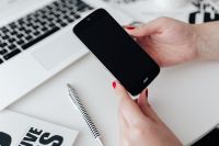 Kaboompics - Businesswoman uses her mobile phone at her desk
