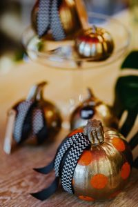 Autumn Pumpkin Decor Still Life with Golden Ornamental Pumpkins and Ribbon Details