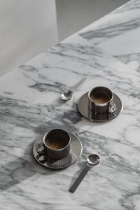 Kaboompics - Vertical Overhead of Two Chrome Espresso Cups and Spoons on Veined Marble
