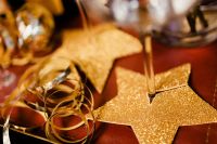 Kaboompics - Glittering Gold Star Table Decoration and Curled Ribbon Beneath Champagne Flute