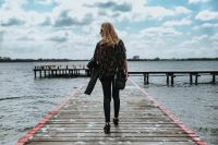 Kaboompics - Beautiful blonde woman on a wooden pier by the lake
