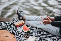 Kaboompics - Blonde woman having a healthy snack at the wooden pier