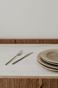 Kaboompics - Portrait Table Setting Background with Neutral Plates and Cutlery and Generous Copy Space