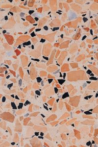 Kaboompics - Peach Terrazzo Pattern with Rust, Black and Gray Stone Fragments