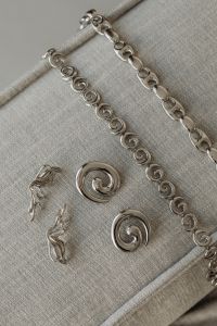 Kaboompics - Assorted Silver Jewelry on a Neutral Sofa