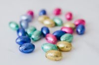 Kaboompics - Scattered Colorful Foil Easter Eggs on a White Background
