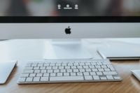 Kaboompics - Front View of Apple iMac Monitor and White Keyboard on a Clean Wooden Desk