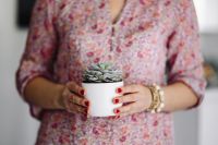 Kaboompics - Woman in pink holding a plant