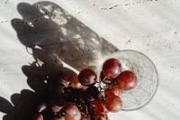 Kaboompics - Close-Up Red Grapes and Glass on Textured White Stone