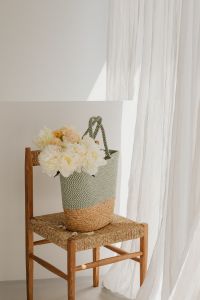 Kaboompics - White Flower Bouquet in Woven Basket on Chair with Sheer Curtains
