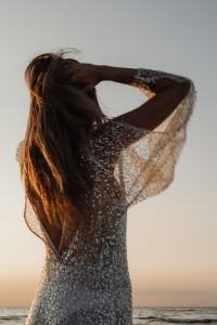 Kaboompics - Faceless Woman in Sequin Dress by the Sea at Golden Hour