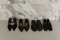 Kaboompics - Row of Black and Brown Shoes Against Marble Wall