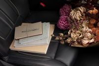 Kaboompics - Beige Journals and an Autumn Bouquet on a Black Car Seat