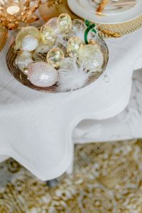 Kaboompics - Top-Down Easter Egg Bowl on White Linen beside a Gold-Rimmed Place Setting