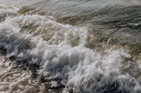 Kaboompics - Bright Whitewater Crest Sweeping Across Gray Sea, Wide Background