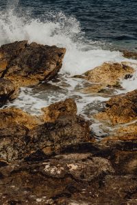 Kaboompics - White Surf Hitting a Large Coastal Rock