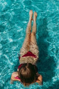 Kaboompics - A beautiful woman in a pool with an inflatable ring