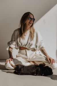 Kaboompics - Woman in a White Outfit Sitting with a Black Cat