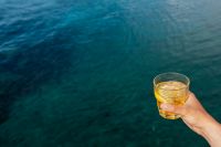 Kaboompics - Yellow Seaside Drink with Open Water Copy Space