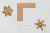 Kaboompics - Blank Holiday Card and Kraft Envelope with Gold Glitter Snowflakes