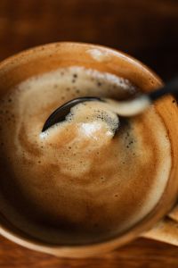 Kaboompics - Close-Up Foamed Coffee with Spoon and Ceramic Cup Rim