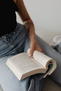 Kaboompics - Open Book on a Woman's Lap During a Quiet Reading Break