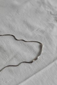 Kaboompics - Silver Chain Necklace Close-Up on White Tablecloth