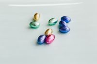Kaboompics - Small Groups of Foil Easter Eggs on White with Copy Space