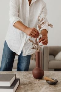 Kaboompics - Woman Arranging Dried Branches in a Vase at Home