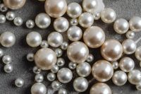 Kaboompics - Close-Up Pearl Bead Background on Textured Gray Surface