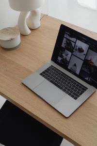 Kaboompics - Laptop And Open Book On Wooden Desk