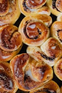 Kaboompics - Golden Iced Cinnamon Rolls Close-Up for Bakery and Dessert Branding