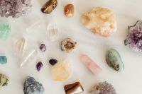 Kaboompics - Wide Flat Lay of Amethyst Clusters, Quartz Crystals and Polished Stones on White