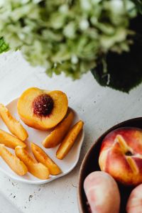 Kaboompics - Close-Up of Sliced Peach, Whole Fruit and Soft Green Background