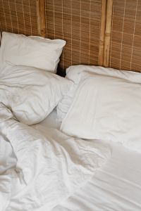 Kaboompics - Close-Up White Bedding Against a Bamboo Headboard