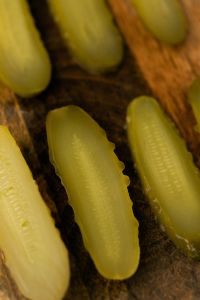 Kaboompics - Macro Pickle Slices on a Rustic Wooden Cutting Board