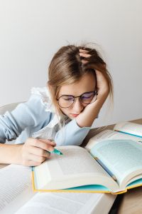 Kaboompics - Close Up of Student Reading and Highlighting Textbook