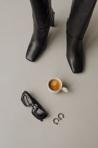 Kaboompics - Black Boots, Espresso and Sunglasses Minimal Flat Lay