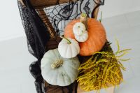 Kaboompics - Halloween Pumpkins and Yellow Flowers on Spiderweb Chair